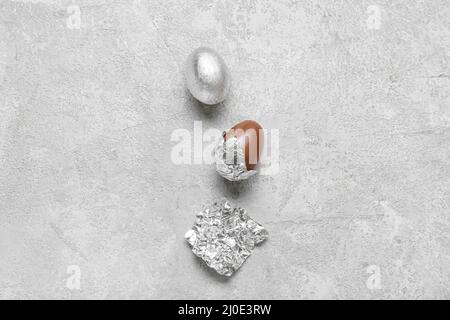 Chocolate eggs in foil on light background Stock Photo