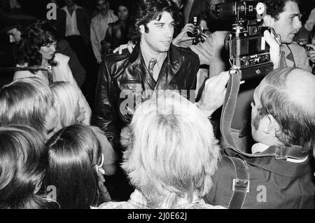 John Travolta, American actor, singer and dancer, in London during the week of release of the film Grease. Grease was released in the UK on 14th September 1978.  Grease is a 1978 American musical romantic comedy film based on Jim Jacobs and Warren Casey's musical of the same name. The film depicts the life of Rydell High School students Danny Zuko and Sandy Olsson in the late 1950s.  Directed by Randal Kleiser and written by Bronte Woodard, the film stars John Travolta as Danny, Olivia Newton-John as Sandy and Stockard Channing as Betty Rizzo. Grease was successful both critically and commerci Stock Photo