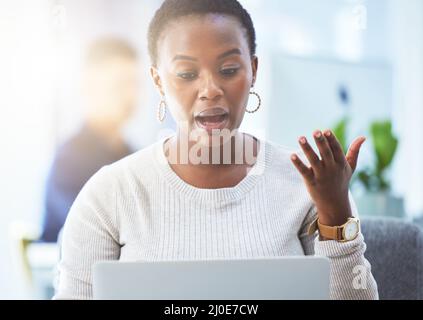 My day is packed with virtual meetings. Shot of a businesswoman talking while using her laptop. Stock Photo