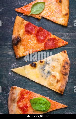 Assorted pizza slices Stock Photo