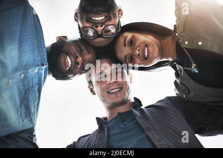 Were looking down on everyone who doubted us. Low angle portrait of a group of young business people posing together in a modern office. Stock Photo