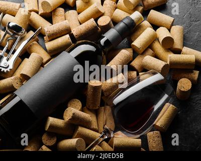 On the wine corks is a bottle of collection wine and a glass. There are no people in the photo. Close-up. Restaurant, hotel, wine tasting, wine cellar Stock Photo
