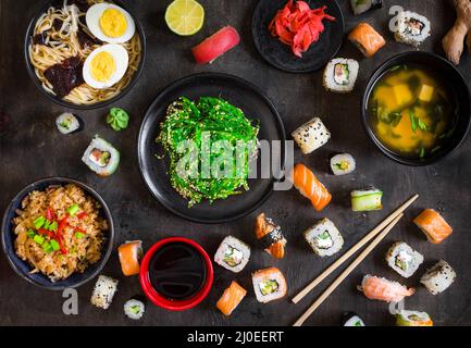 Table served with sushi and traditional japanese food Stock Photo