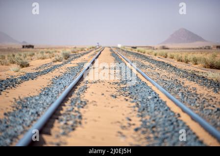 Railway line for iron ore trains in the Sahara desert near Choum, Mauritania Stock Photo