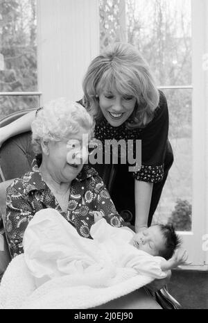 'That's Life' presenter Esther Rantzen presents her month old baby Emily to Annie Mizen today. Annie, 86, who became famous on That's Life by eating caviar and Chinese food, testing drinks and dancing in the street, was invited to elevenses at Esther's home and to meet Emily. 22nd February 1978. Stock Photo