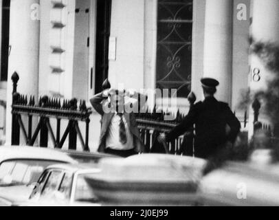 Final day of the Iranian Embassy Siege in London where six gunmen of the Iranian extremist group 'Democratic Revolutionary Movement for the Liberation of Arabistan' stormed the building, taking 26 hostages before the SAS retook the embassy and freed the hostages. One of  the hostages with hands above his head as he is released from the Embassy. 5th May 1980. Stock Photo