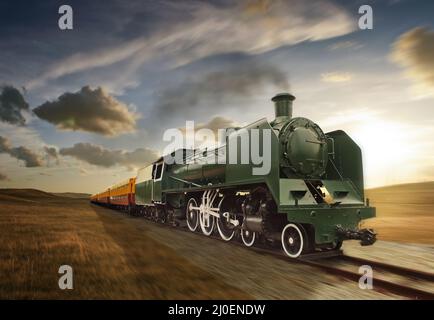 Vintage green and yellow steam powered railway train moving Stock Photo