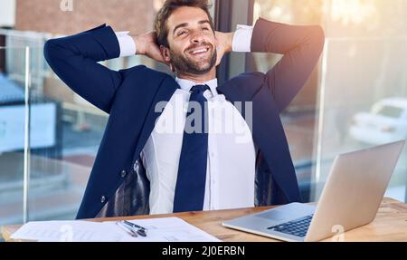 Business is going good. Shot of a businessman looking relaxed in his office. Stock Photo
