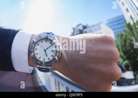 Personal perspective of a caucasian businessman looking at his wristwatch Stock Photo