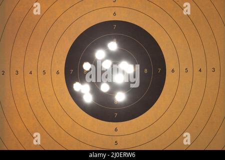 Close up of a shooting target with backlit bullet holes Stock Photo