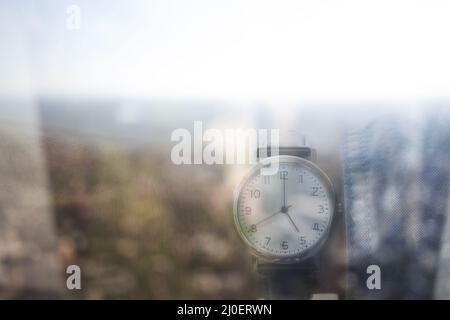Reflection personal perspective of a caucasian businessman looking at his wristwatch in the office Stock Photo