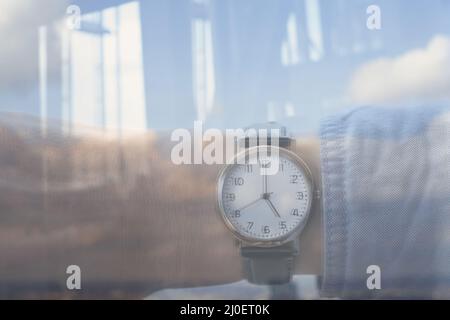 Reflection personal perspective of a caucasian businessman looking at his wristwatch in the office Stock Photo