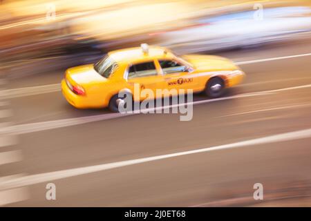 Panning image of a Yellow Taxi cab in Times Square, New York City. New York. USA Stock Photo
