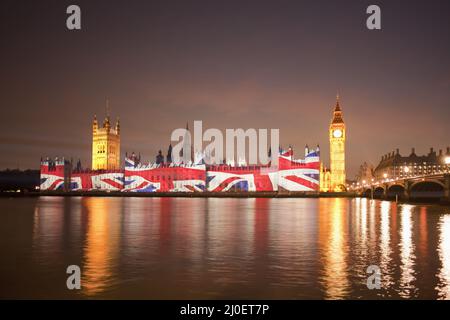 Union Jack Flag projected onto the Houses of Parliament at dusk Stock Photo
