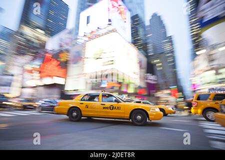 Panning image of a Yellow Taxi cab in Times Square, New York City. New York. USA Stock Photo