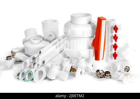 White plastic pipes and PVC fittings for plumbing on an background Stock Photo