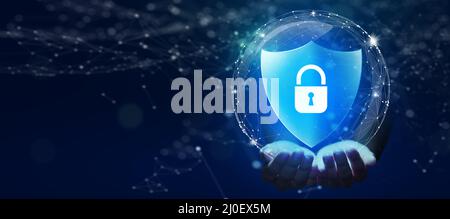 Business Hand holding Shield with Padlock icon and Network wireframe over blue background abstract. Cyber attack block, Cyber data, and Information. Stock Photo