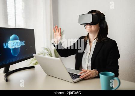 Metaverse technology concept - Business woman doing video call wearing virtual reality headset - Focus on goggles Stock Photo