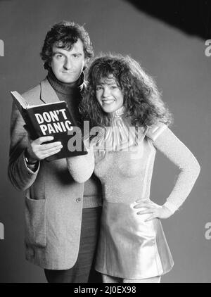 After becoming a cult science fiction comedy series on BBC Radio, 'The Hitchhikers Guide to the Galaxy' by Douglas Adams is now a top selling book, a record, and TV and film projects are underway.Here author Douglas Adams poses with model Sheree Boyland as book hero Trillian, holding a copy of the book. 29th November 1979. Stock Photo