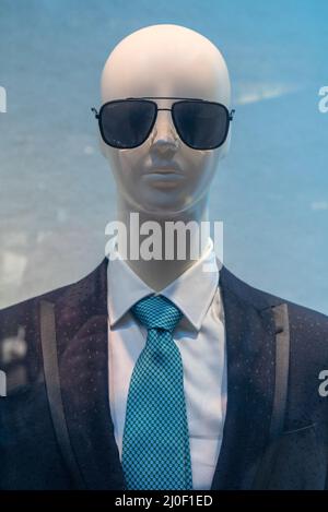 Male dummy in a shop window. Sale of men's clothing. Stock Photo