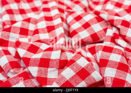 Red checkered kitchen towel. Beautiful decorative folds. Stock Photo