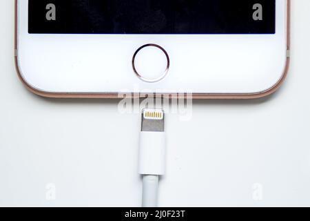 Calgary, Alberta. Canada Dec 12, 2019. Close up of an iPhone Plus and a Lightning to USB Cable. Apple is killing Lightning conne Stock Photo