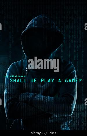 Luring in his prey. Portrait of a menacing computer hacker posing against a dark background in studio. Stock Photo