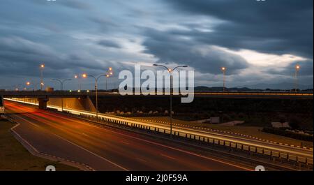 Light trails from fast moving cars on a highway Stock Photo