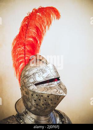 Russia, Sochi 14.03.2020. A medieval knight's metal helmet with patterned chasing and a long ostrich red feather Stock Photo