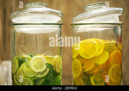 2 glass jars of lime and orange slices lemonade, cut into pieces Stock Photo