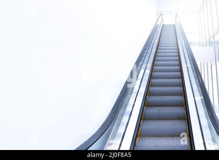 Modern escalator view from below. Stock Photo