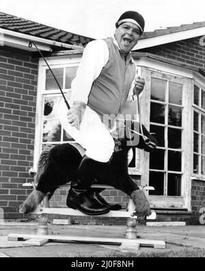 A picture from a series of humurous novelty images taken by Sunday People photographer Dennis Hutchinson. - Darts player Jocky Wilson having fun on a rocking horse. Stock Photo