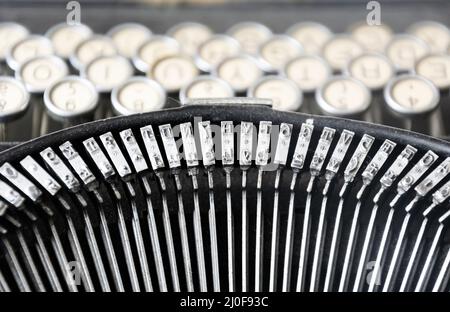 The iron hammers of an old typewriter Stock Photo