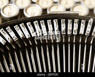 The iron hammers of an old typewriter Stock Photo