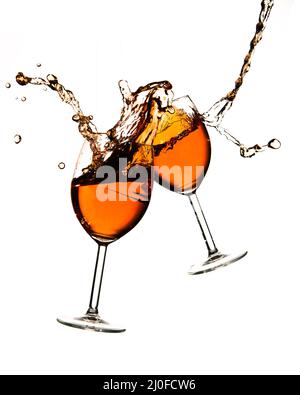 Broken wine glasses with wine splashes on a white background Stock Photo