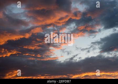 Dramatic sunset sky with orange cloud colors Stock Photo