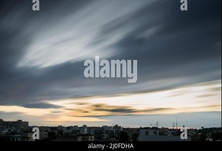 Moving clouds during sunset Stock Photo