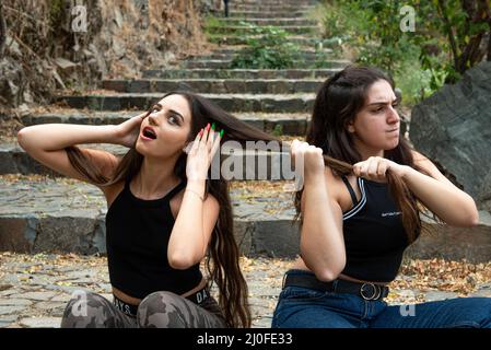 Two women fighting and pulling each others hair Stock Photo