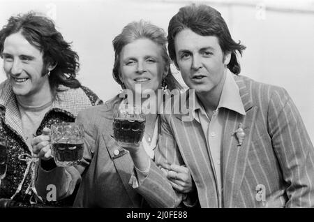 Paul McCartney and his wife Linda of pop group Wings enjoy a pint of ale as they make a film to promote their new single 'With A Little Luck' in London. Left is Denny Laine Middle is Linda McCartney Right is Paul McCartney   Picture taken 22nd March 1978. Stock Photo