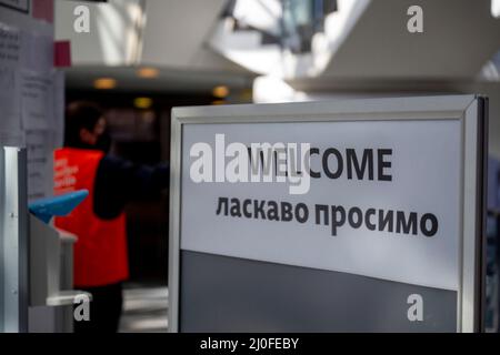 Berlin, Germany. 18th Mar, 2022. 'Welcome' in English and Ukrainian is written on a board at the entrance to the main terminal of the former Berlin-Tegel Airport. In the rooms of the old main terminal of the TXL airport, an arrival center for Ukrainian war refugees has been built in recent weeks. (to dpa 'Bunk beds and children's pictures - new life at old Tegel airport') Credit: Monika Skolimowska/dpa-Zentralbild/dpa/Alamy Live News Stock Photo