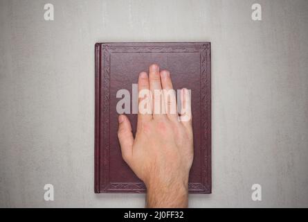 A man's palm on a book Stock Photo