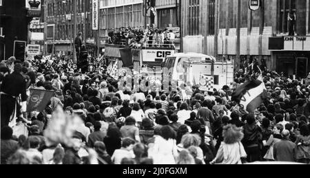 Enthusiastic Liverpool fans gathered in the city centre, to welcome their team home from Wembley after their victory in the European Cup Final. The team parade the famous trophy to thousands of fans gatherd in the streets with an open top bus parade through the city centre. 11th May 1978. Stock Photo