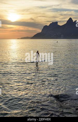 Stand up paddle at sunset Stock Photo