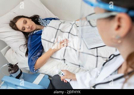 The nurse interviews the patient after an infectious disease. Cured of COVID-19. Stock Photo