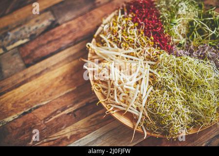 Vegetarian concept food. A set of different sprouted seeds for healthy eating on a wooden plate Stock Photo