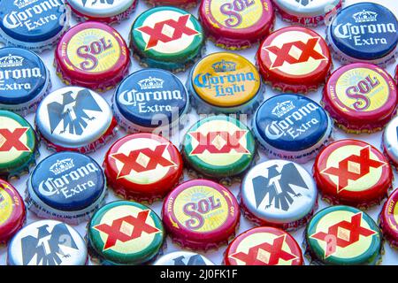 Calgary, Alberta, Canada. Oct 25, 2020. Popular Mexican beer caps on a clear background. Corona Extra, Corona Light, Dos Equis a Stock Photo