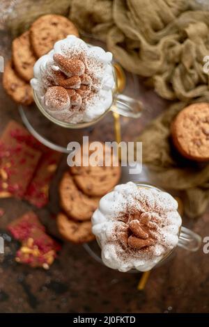 Sweet dessert served. Hot chocolate with whipped cream on top and cookies Stock Photo