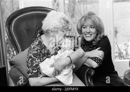 'That's Life' presenter Esther Rantzen presents her month old baby Emily to Annie Mizen today. Annie, 86, who became famous on That's Life by eating caviar and Chinese food, testing drinks and dancing in the street, was invited to elevenses at Esther's home and to meet Emily. 22nd February 1978. Stock Photo