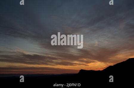 Mountain range and dramatic sky during sunset Stock Photo