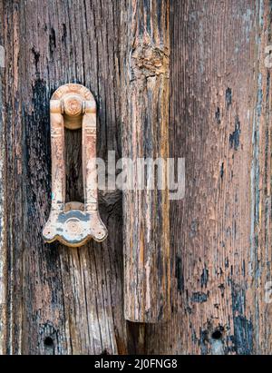 Metal handle on a vintage wooden door. Stock Photo
